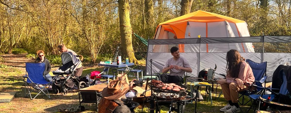 Group camping in a woodland glade